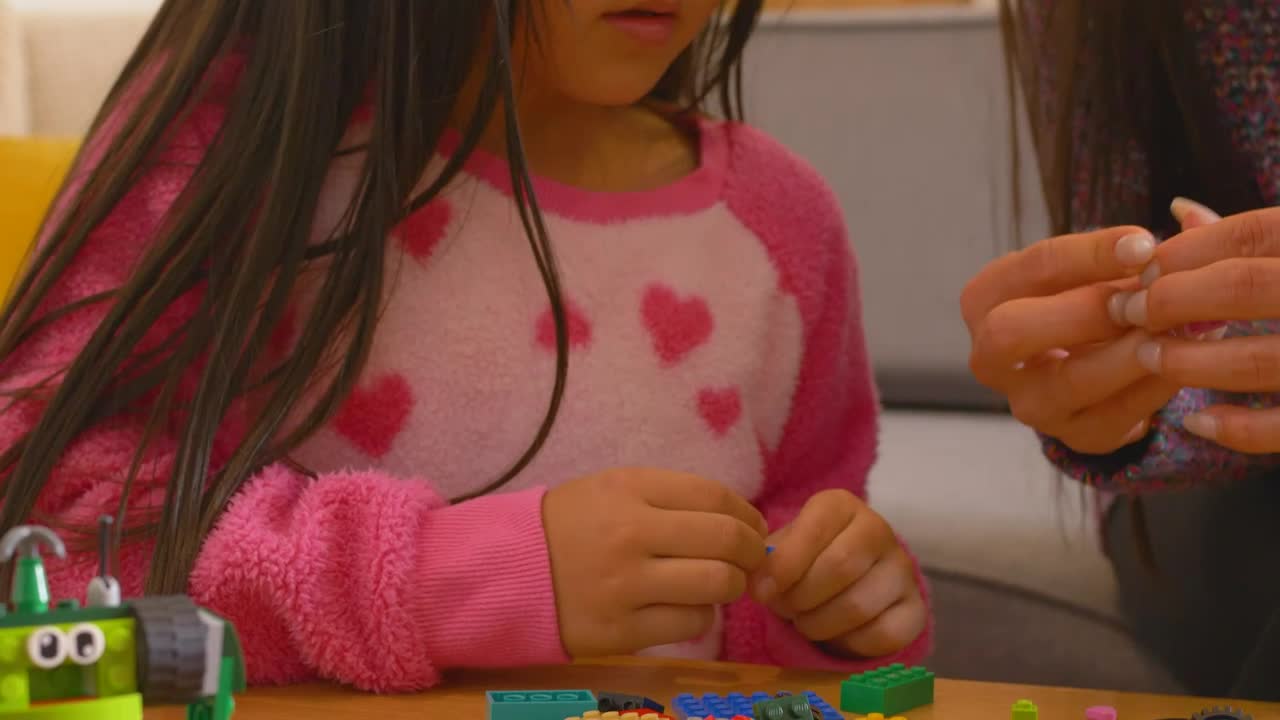 Stock Video Little Girl Playing With Legos With Mom Animated Wallpaper
