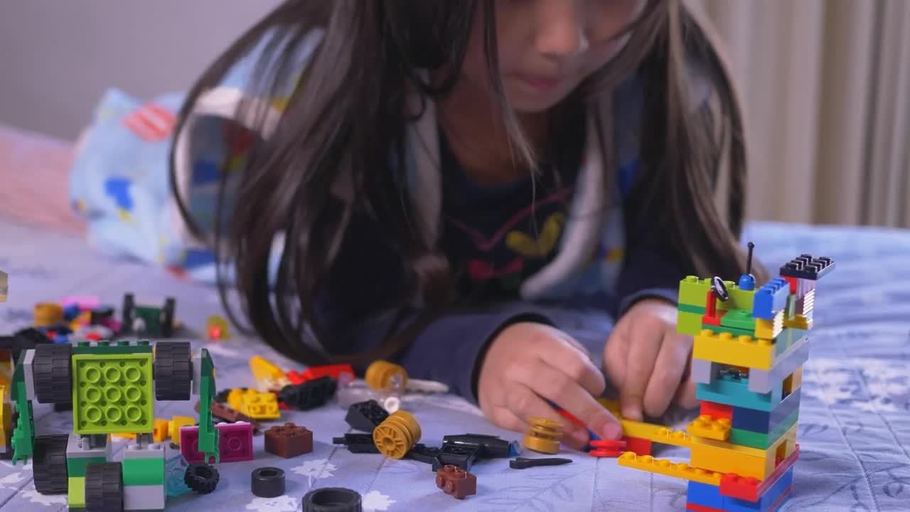 Stock Video Little Girl Playing On Her Bed With Legos Animated Wallpaper