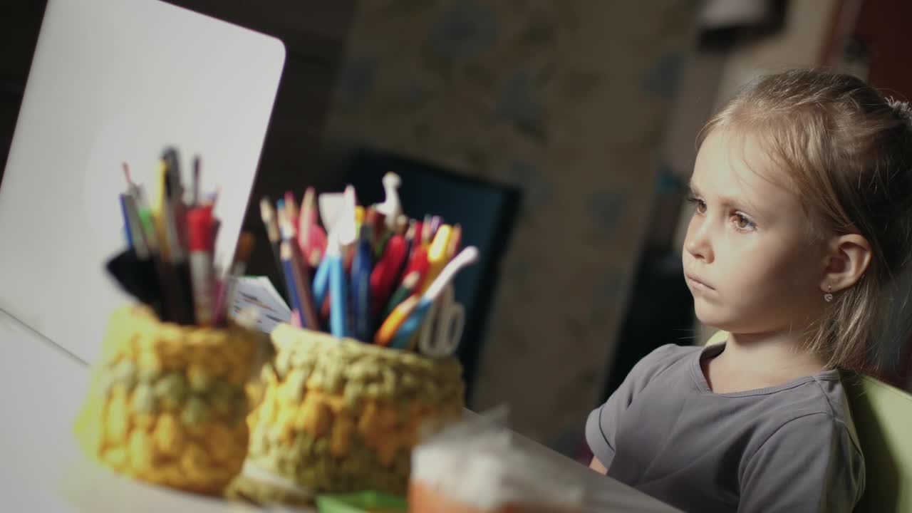 Stock Video Little Girl Paying Attention To Online Class At Home Animated Wallpaper