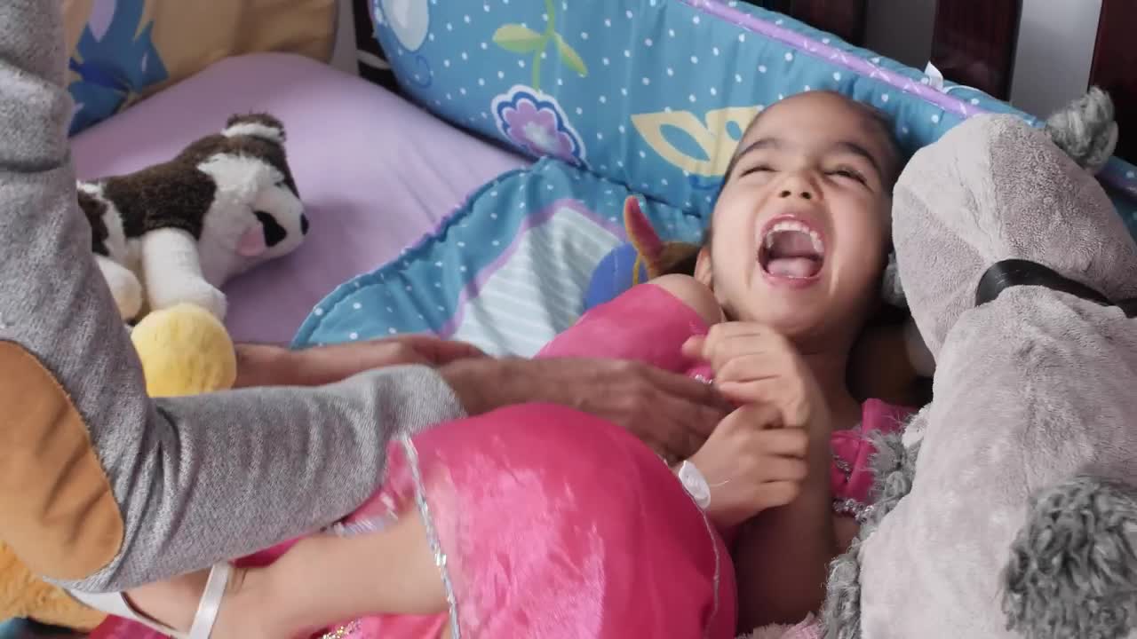 Stock Video Little Girl Lying Down While Her Father Tickles Her Animated Wallpaper
