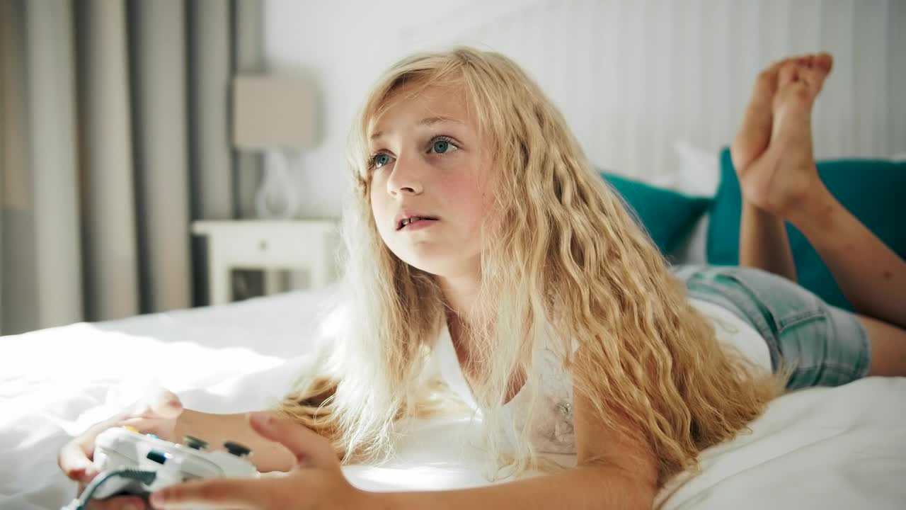 Stock Video Little Girl Happy To Win Playing A Video Game Animated Wallpaper