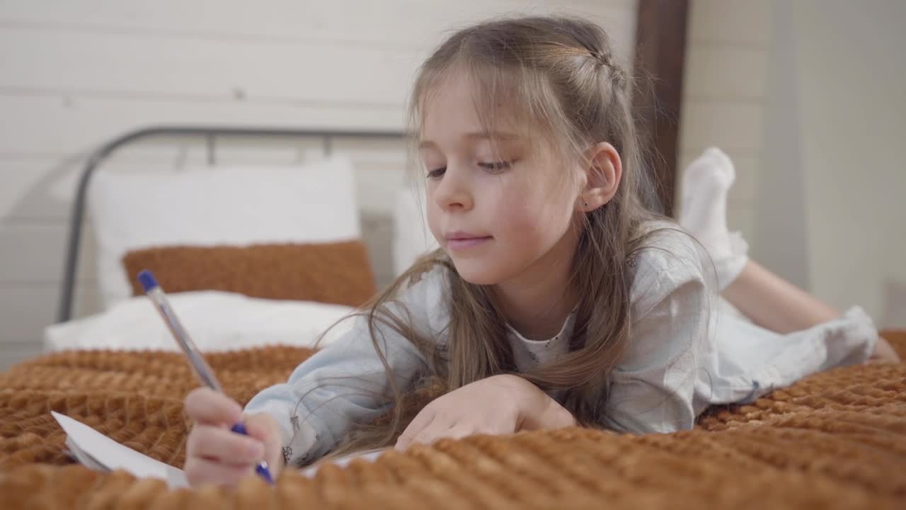 Stock Video Little Girl Enjoys Drawing Hobby On Bed Animated Wallpaper