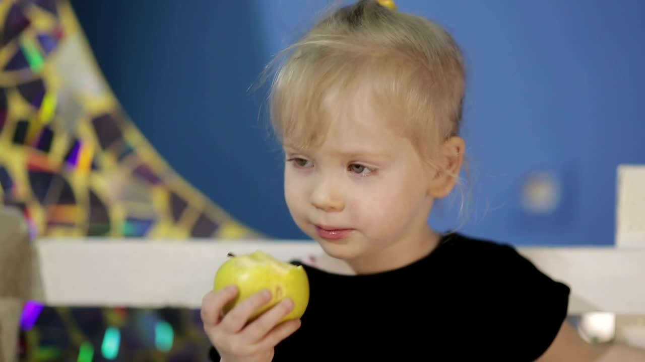 Stock Video Little Girl Eating An Apple Animated Wallpaper