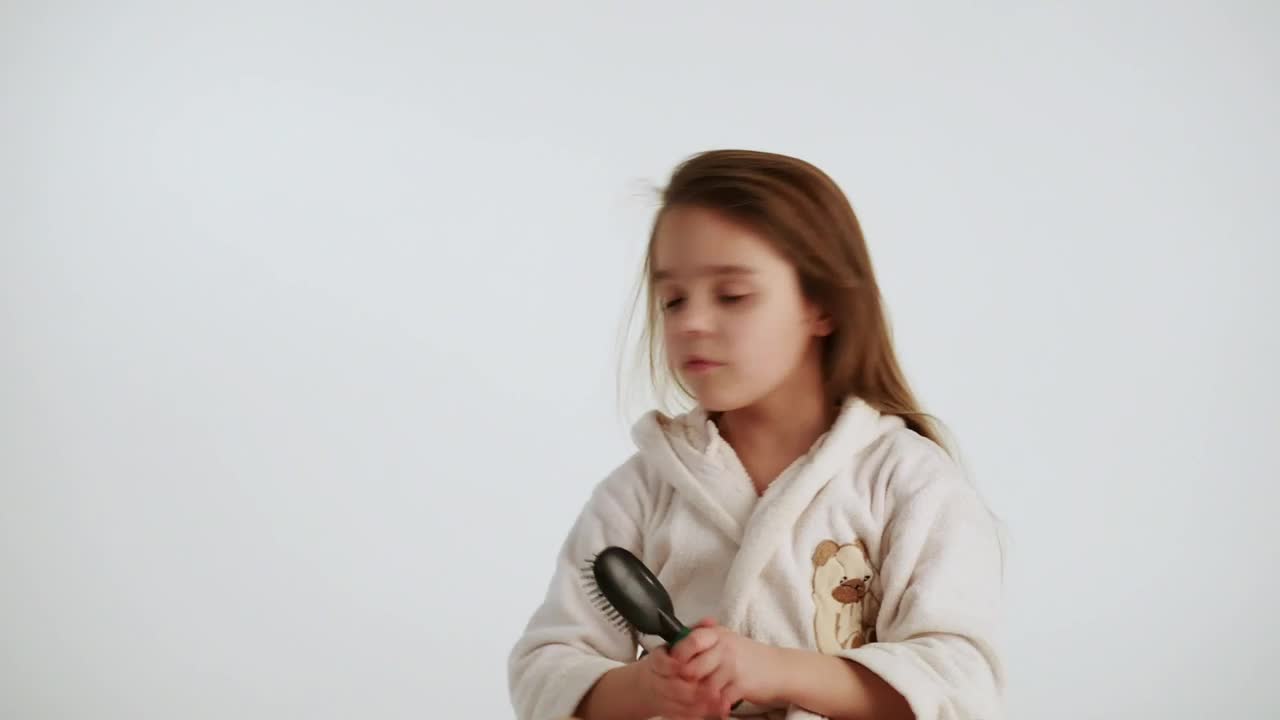 Stock Video Little Girl Combing Her Hair After Shower Animated Wallpaper