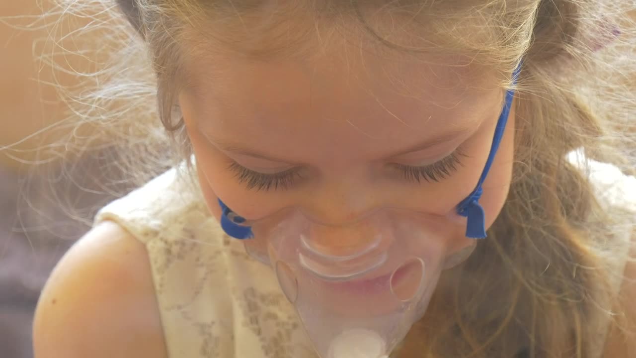 Stock Video Little Girl Breathing With A Facemask Animated Wallpaper