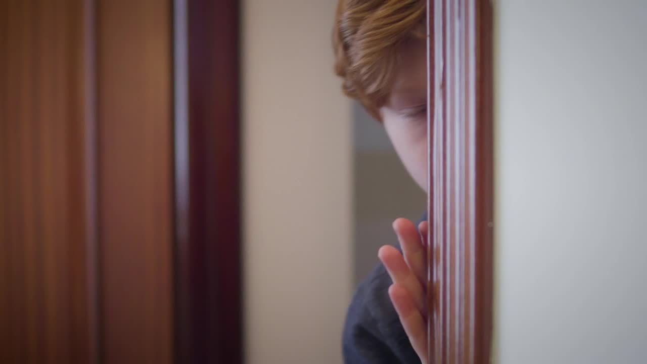 Stock Video Little Boy Peeks Around Corner In Fear Animated Wallpaper