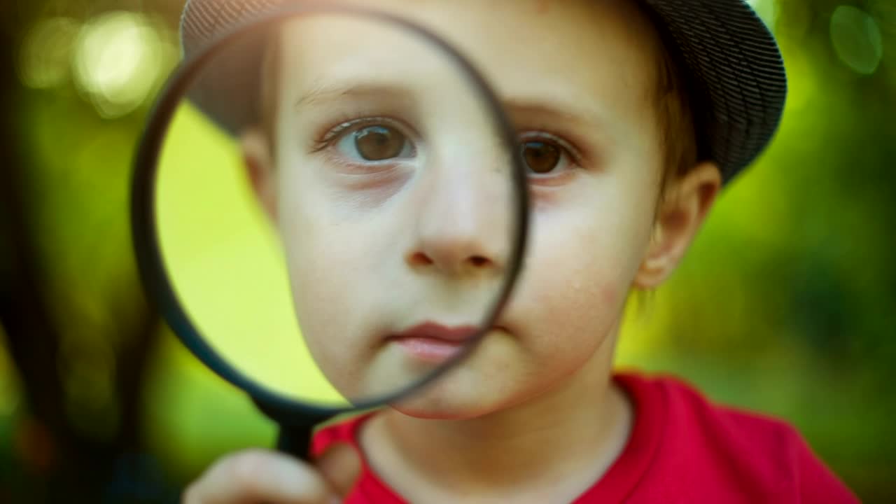 Stock Video Little Boy Looking Through A Magnifying Glass Animated Wallpaper