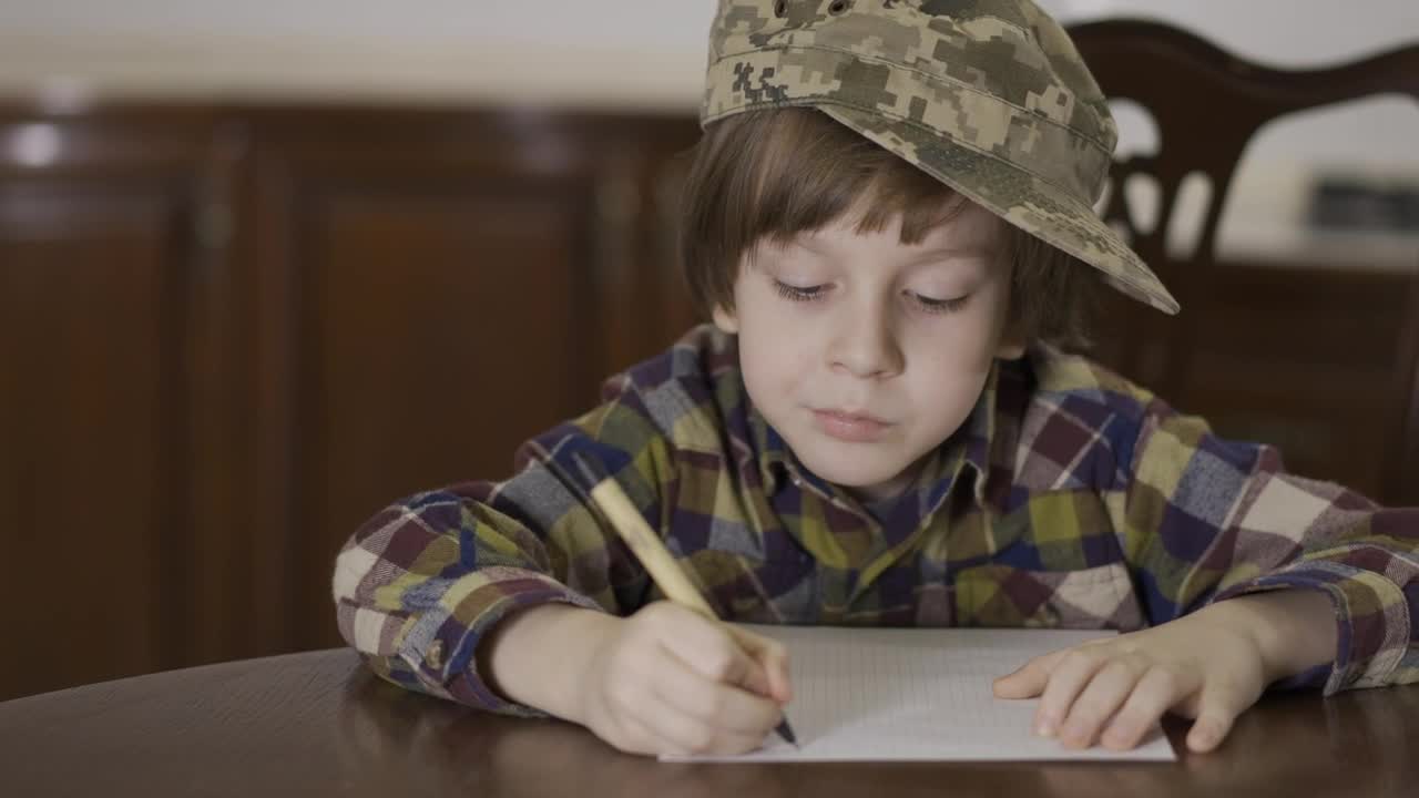 Stock Video Little Boy In Army Hat Writing Letter To Soldier Animated Wallpaper