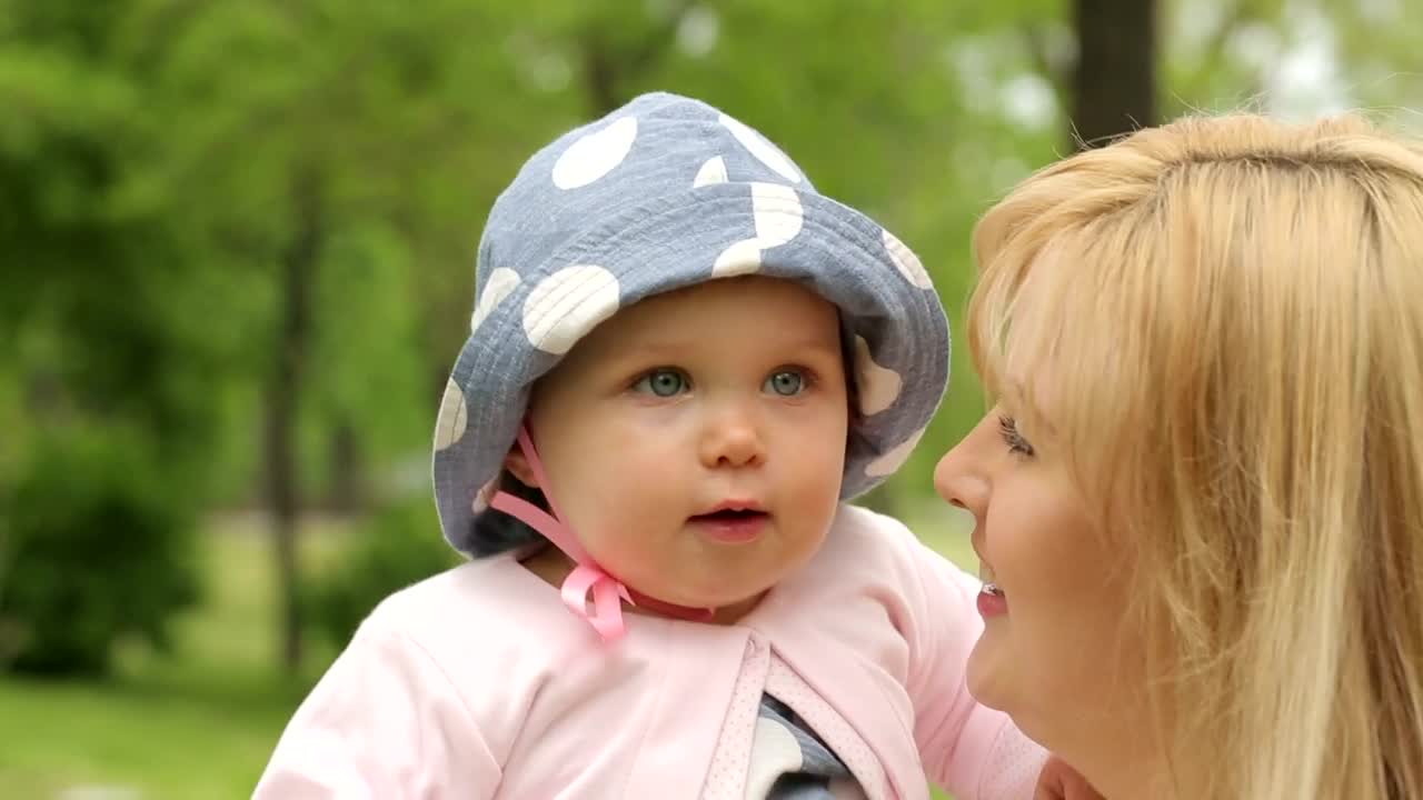 Stock Video Little Baby In His Mothers Arms Looking Around Animated Wallpaper