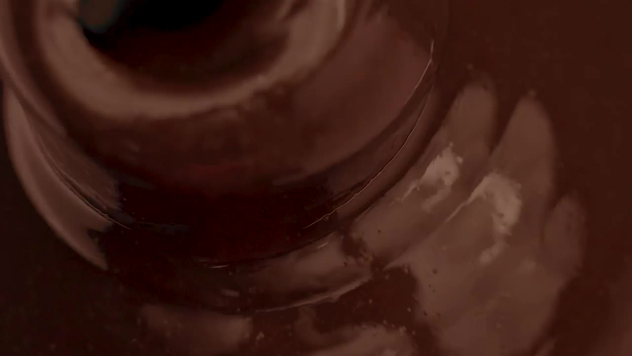 Stock Video Liquid Chocolate Flowing Into A Chocolate Fountain Animated Wallpaper