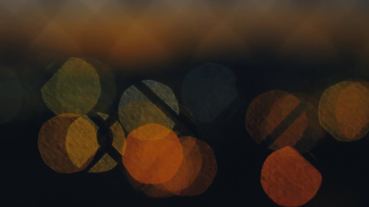 Stock Video Lights Out Of Focus Through A Wire Fence Animated Wallpaper