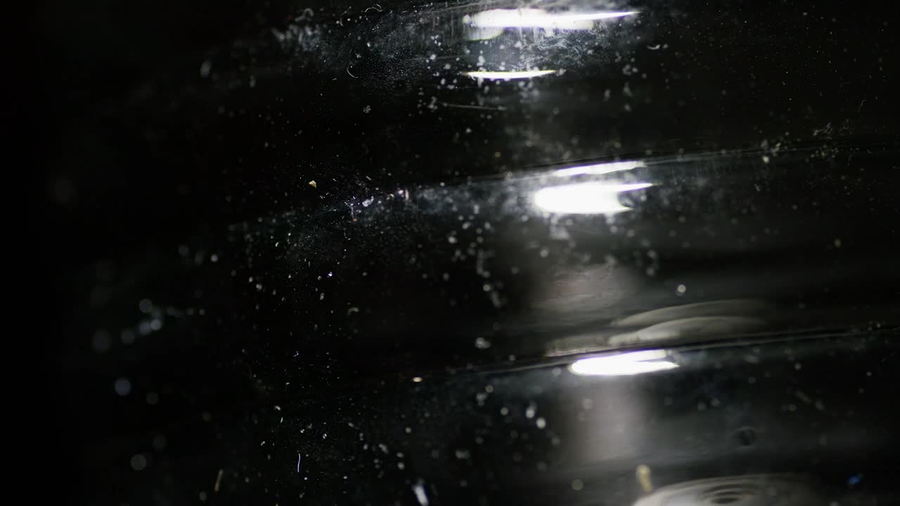 Stock Video Light Reflection On Black Surface Animated Wallpaper