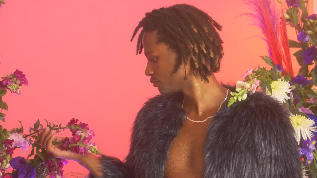 Stock Video Lgbtq Man Among Flowers While Appreciating Them Animated Wallpaper