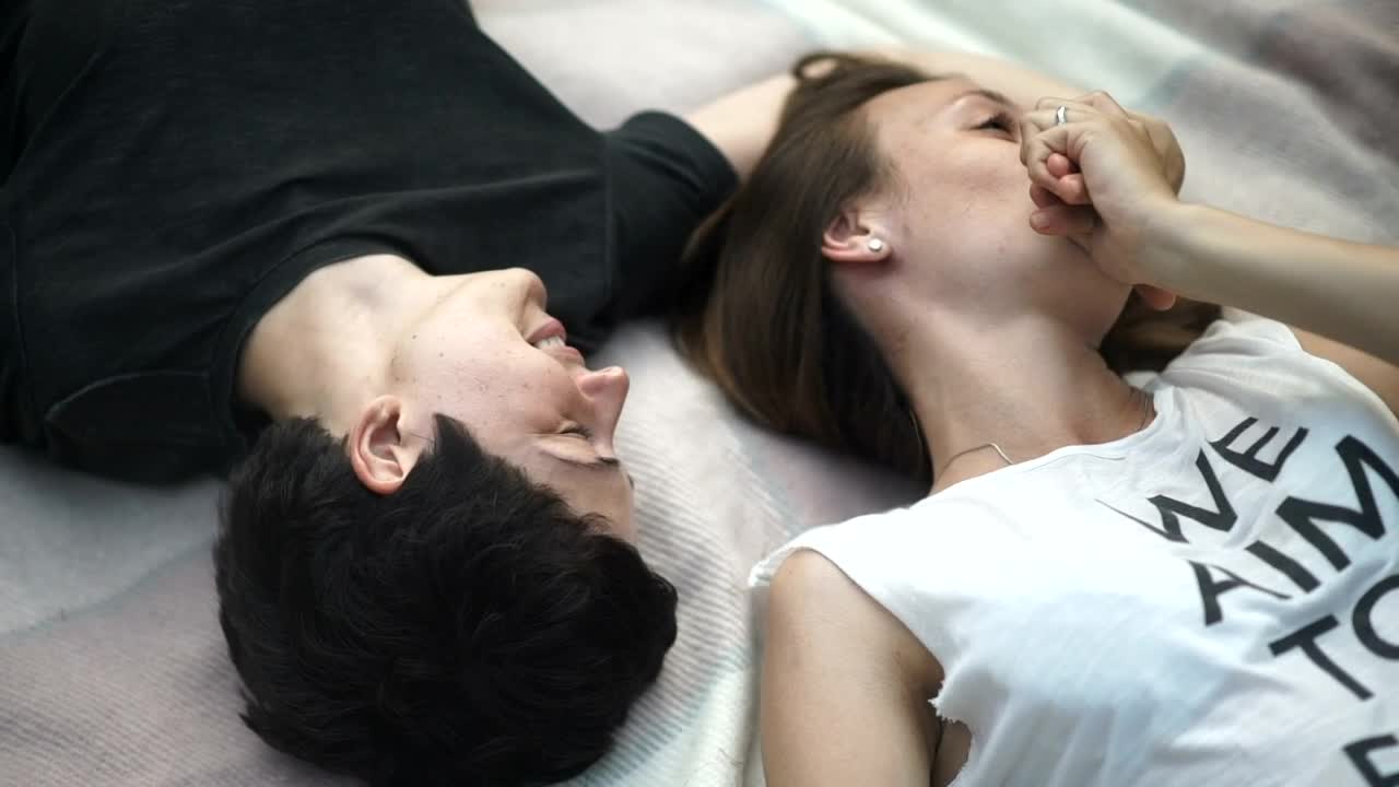 Stock Video Lgbtq Couple Talk And Kiss Lying Opposite On Bed Animated Wallpaper