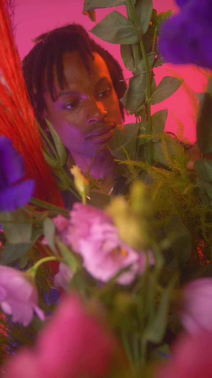 Stock Video Lgbtq Boy Looking At Camera Surrounded By Flowers Animated Wallpaper