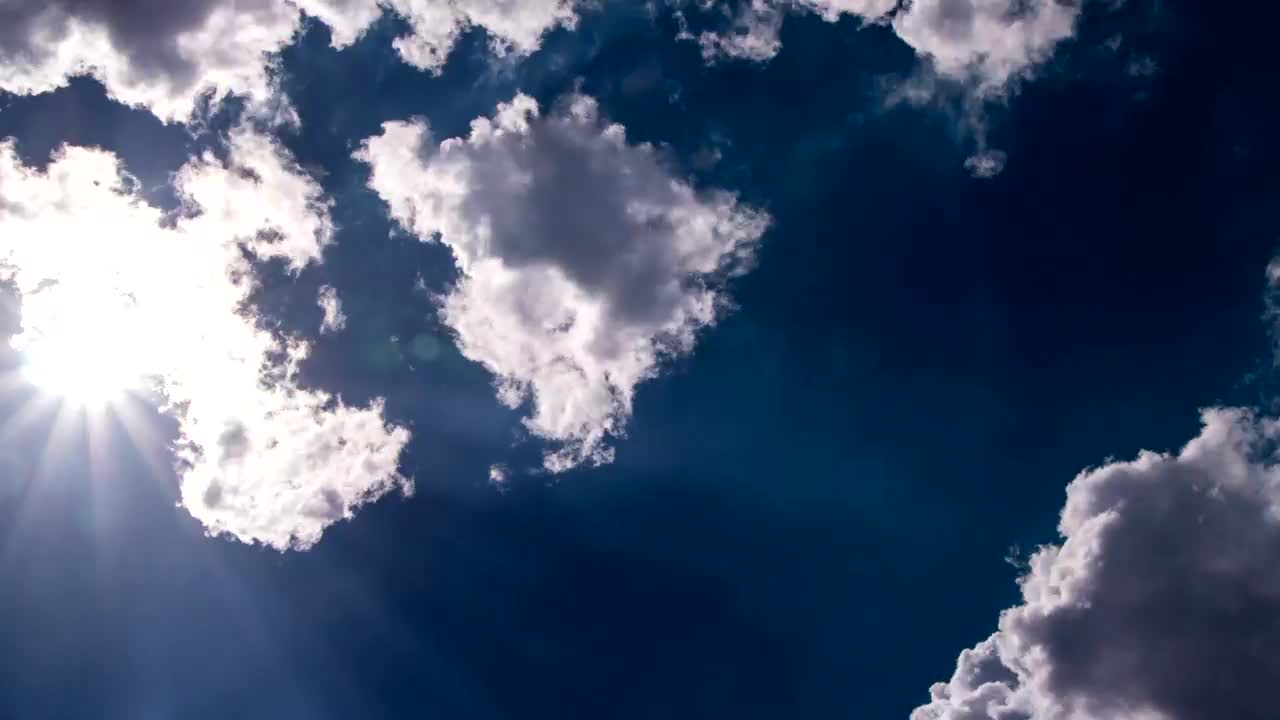 Stock Video Lens Flare Through White Clouds Animated Wallpaper