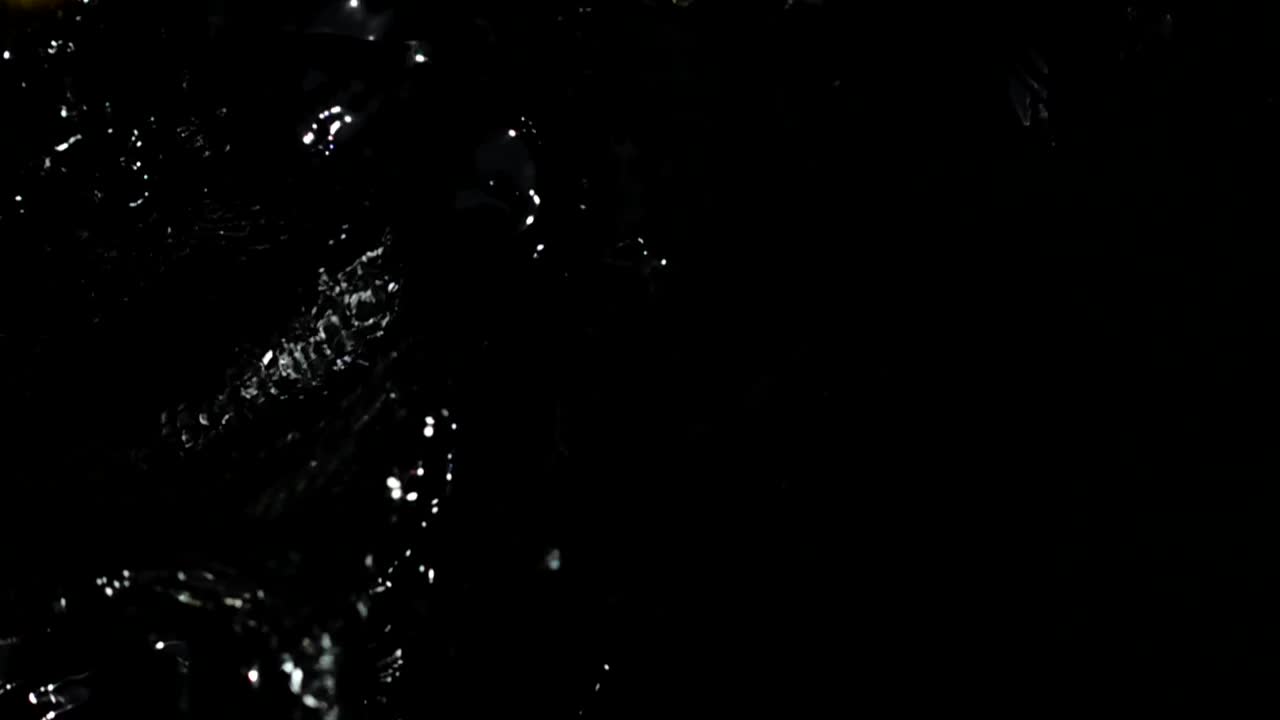 Stock Video Lemon Slices Falling Into Dark Water Animated Wallpaper