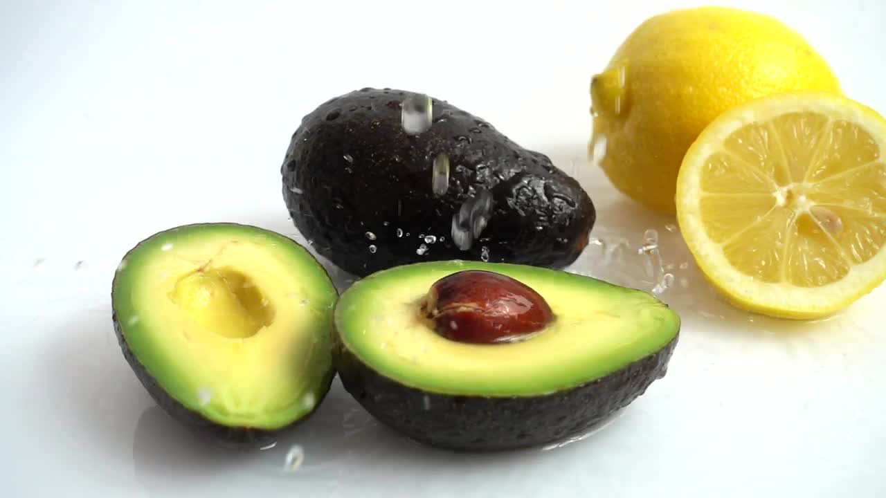 Stock Video Lemon And Avocado Being Wet By A Jet Of Water Animated Wallpaper