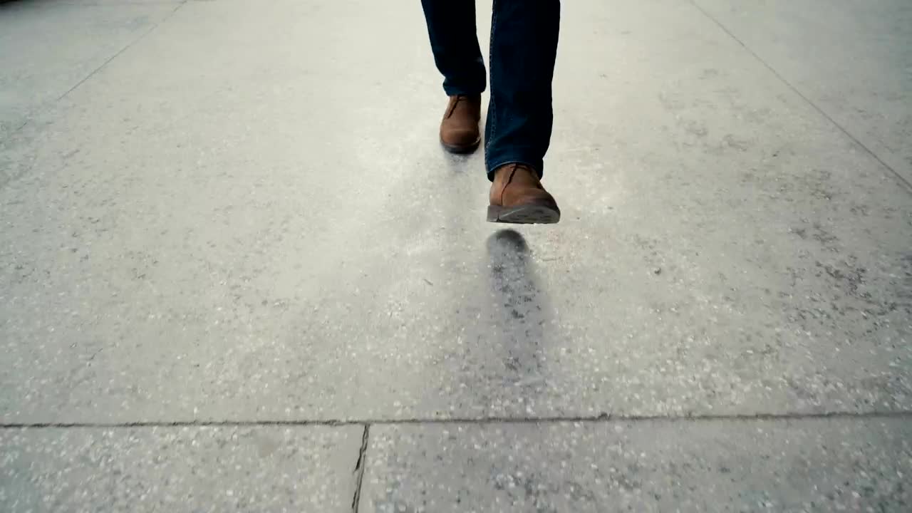 Stock Video Legs Of A Man Walking On The Street Animated Wallpaper