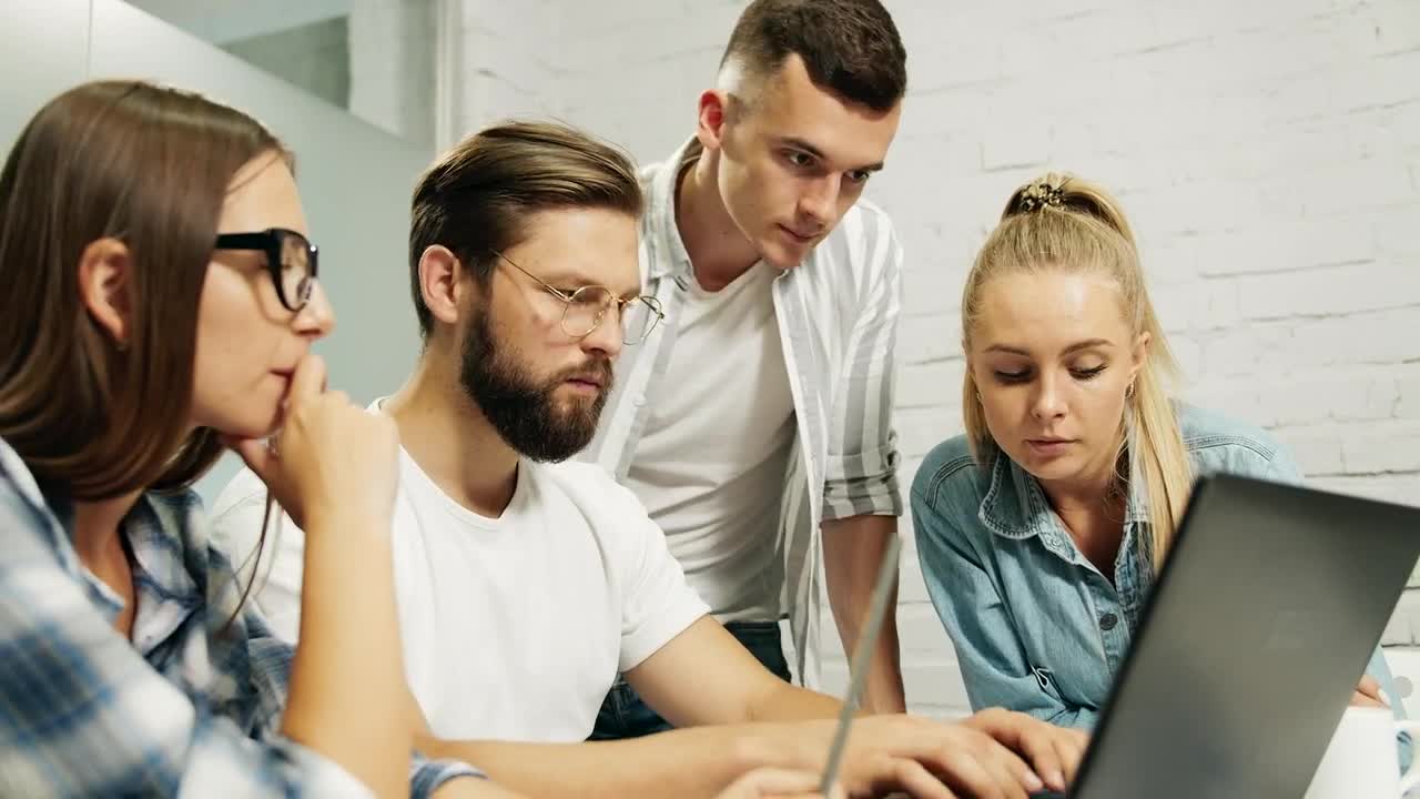 Stock Video Leader Types On Laptop While Team Look Over Shoulder Animated Wallpaper