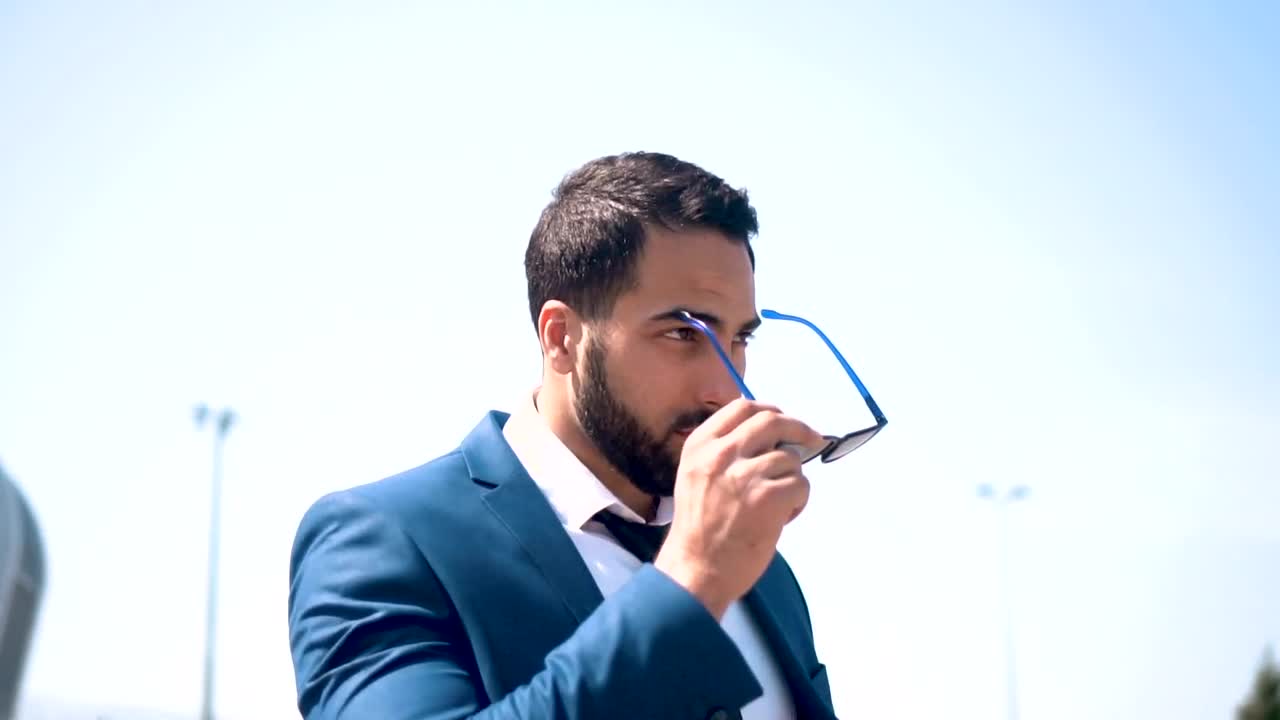 Stock Video Lawyer Puts On Sunglasses In Front Of Modern Building Animated Wallpaper