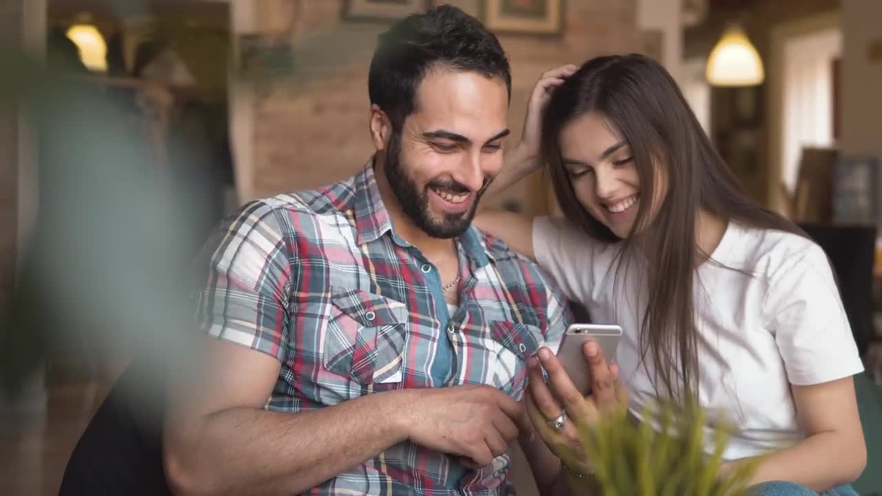 Stock Video Laughing Couple Scroll Through Social Media On Mobile Animated Wallpaper