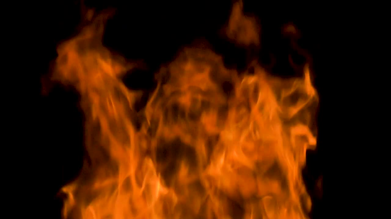 Stock Video Large Orange Flames On Black Background Animated Wallpaper