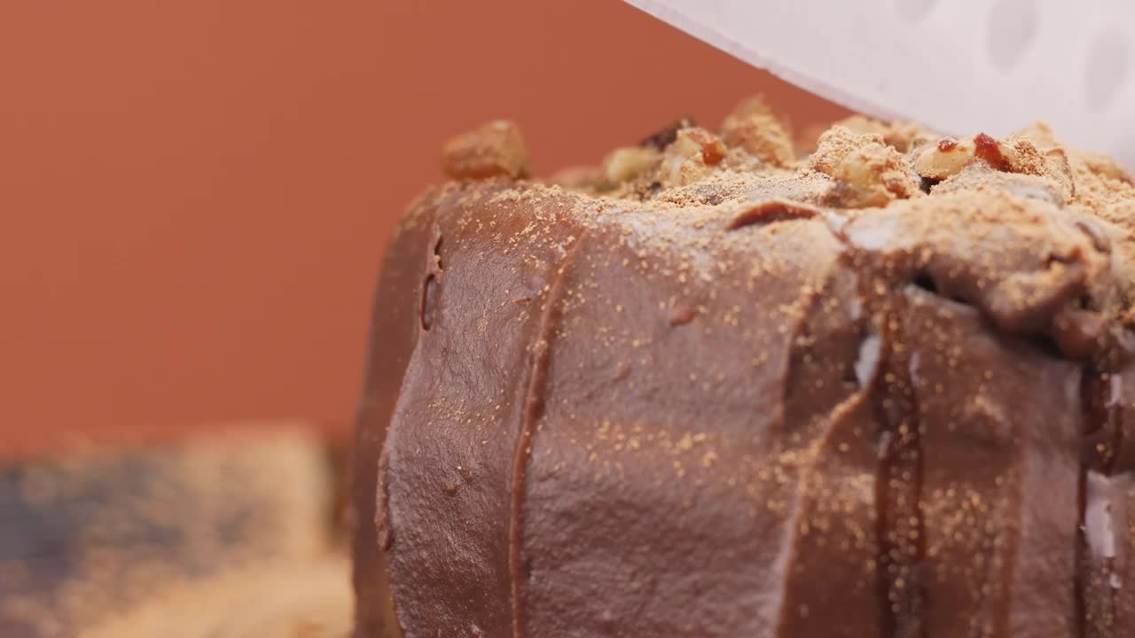 Stock Video Large Knife Splitting A Small Chocolate Cake Animated Wallpaper