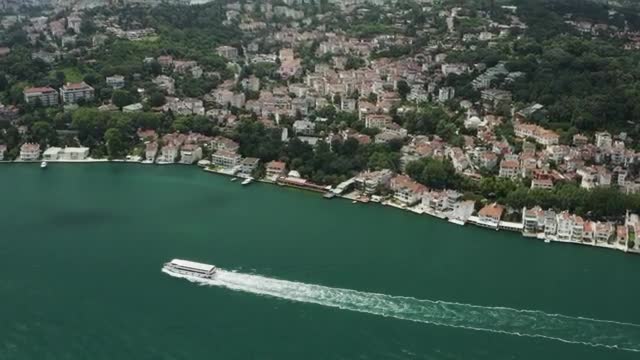Stock Video Large Boat Heading By The Waterfront Smal Animated Wallpaper