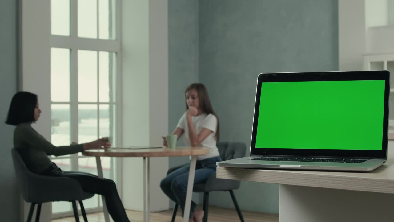 Stock Video Laptop And Women Talking In The Background Animated Wallpaper