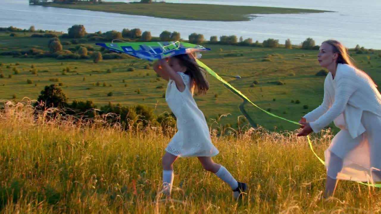 Stock Video Mother With Her Daughter Running On The Field With Animated Wallpaper