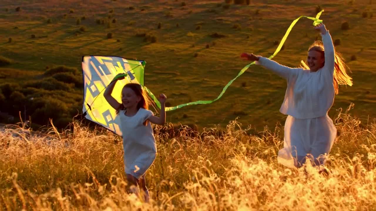 Stock Video Mother With Her Daughter Running On The Hill With Animated Wallpaper