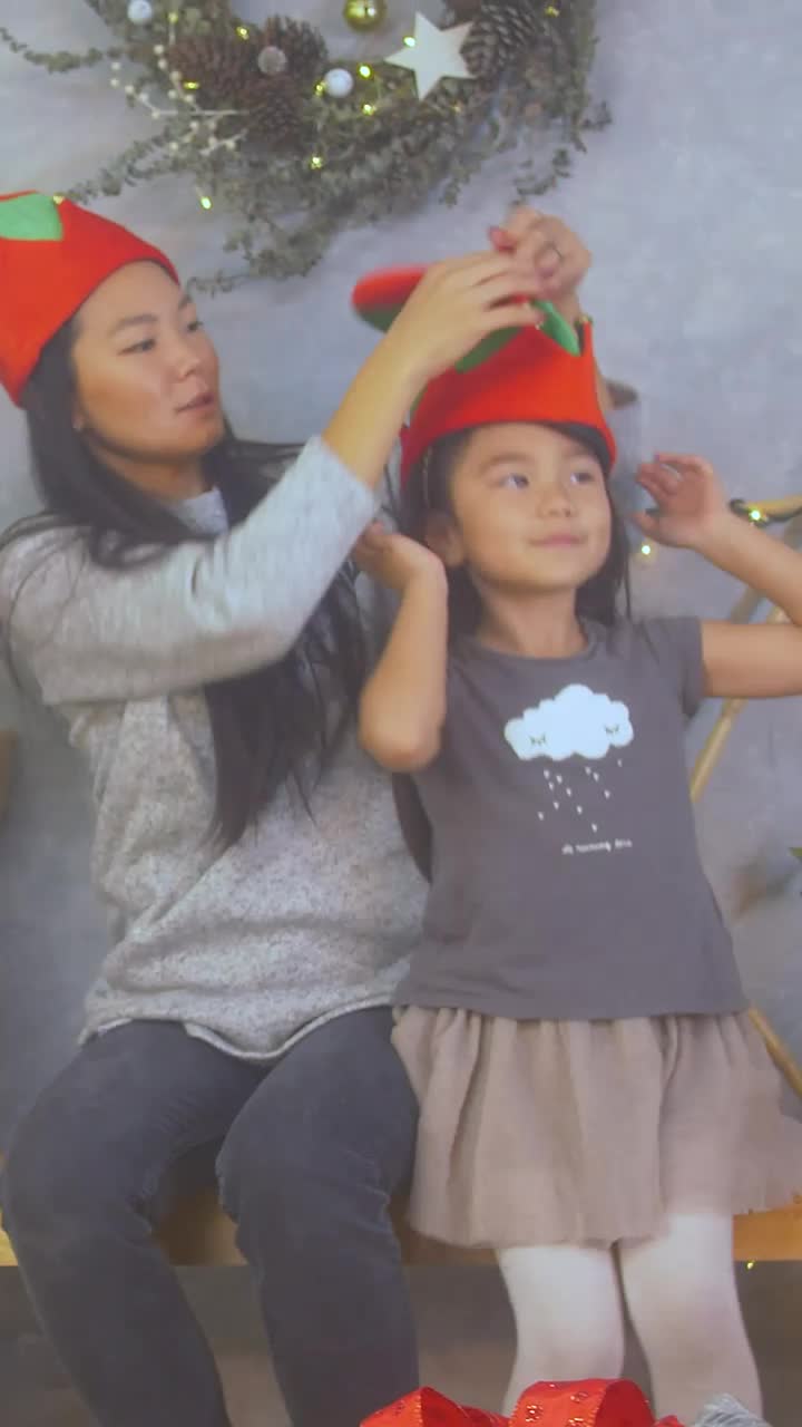 Stock Video Mother Trying On Christmas Hats With Her Little Daughte Animated Wallpaper