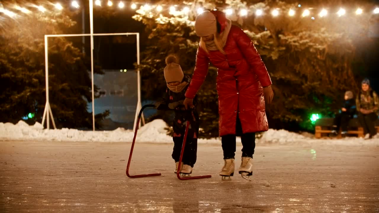 Stock Video Mother Teaching Her Daughter To Ice Skatin Animated Wallpaper
