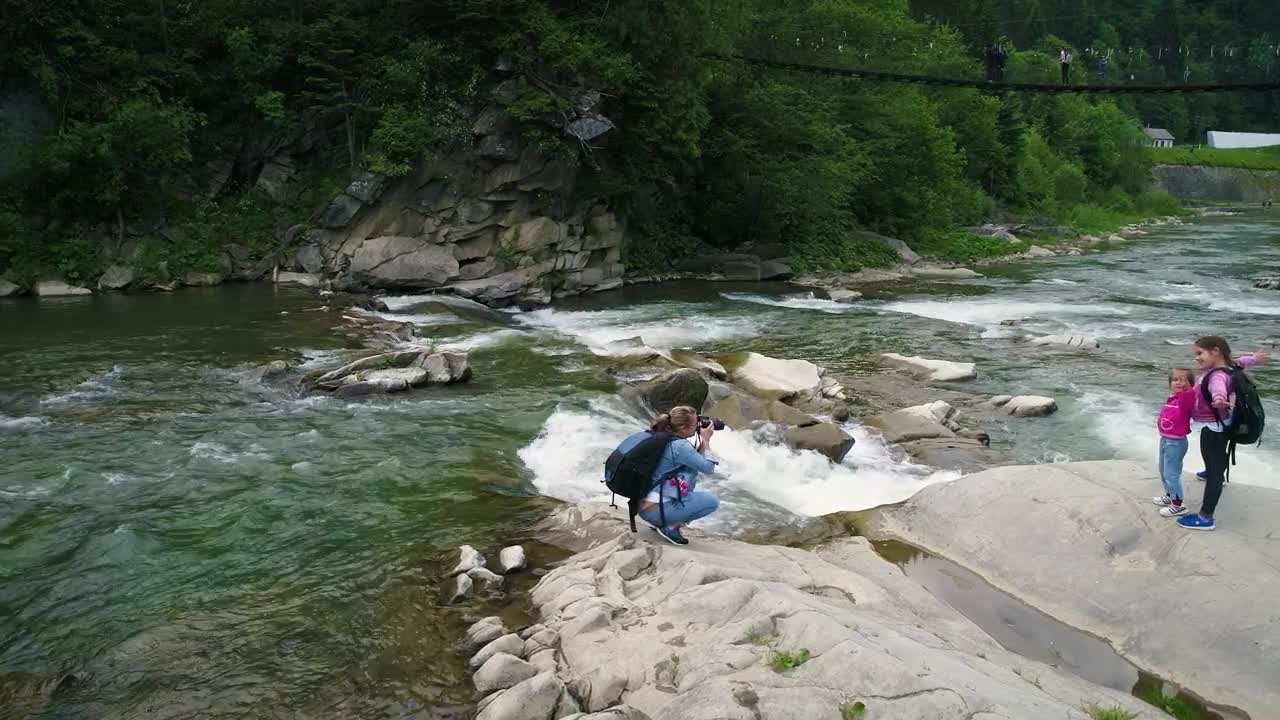 Stock Video Mother Taking Photos In The River With Her Daughter Animated Wallpaper