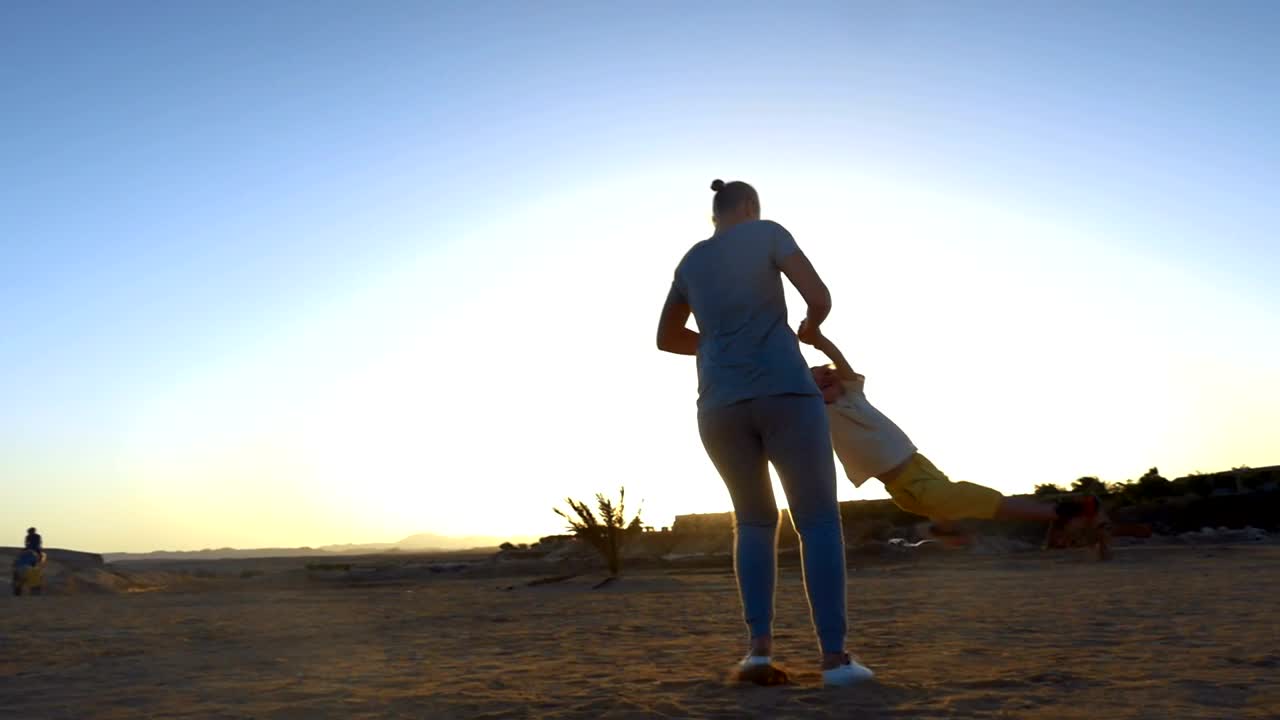 Stock Video Mother Swinging Her Child Around At The Beac Animated Wallpaper