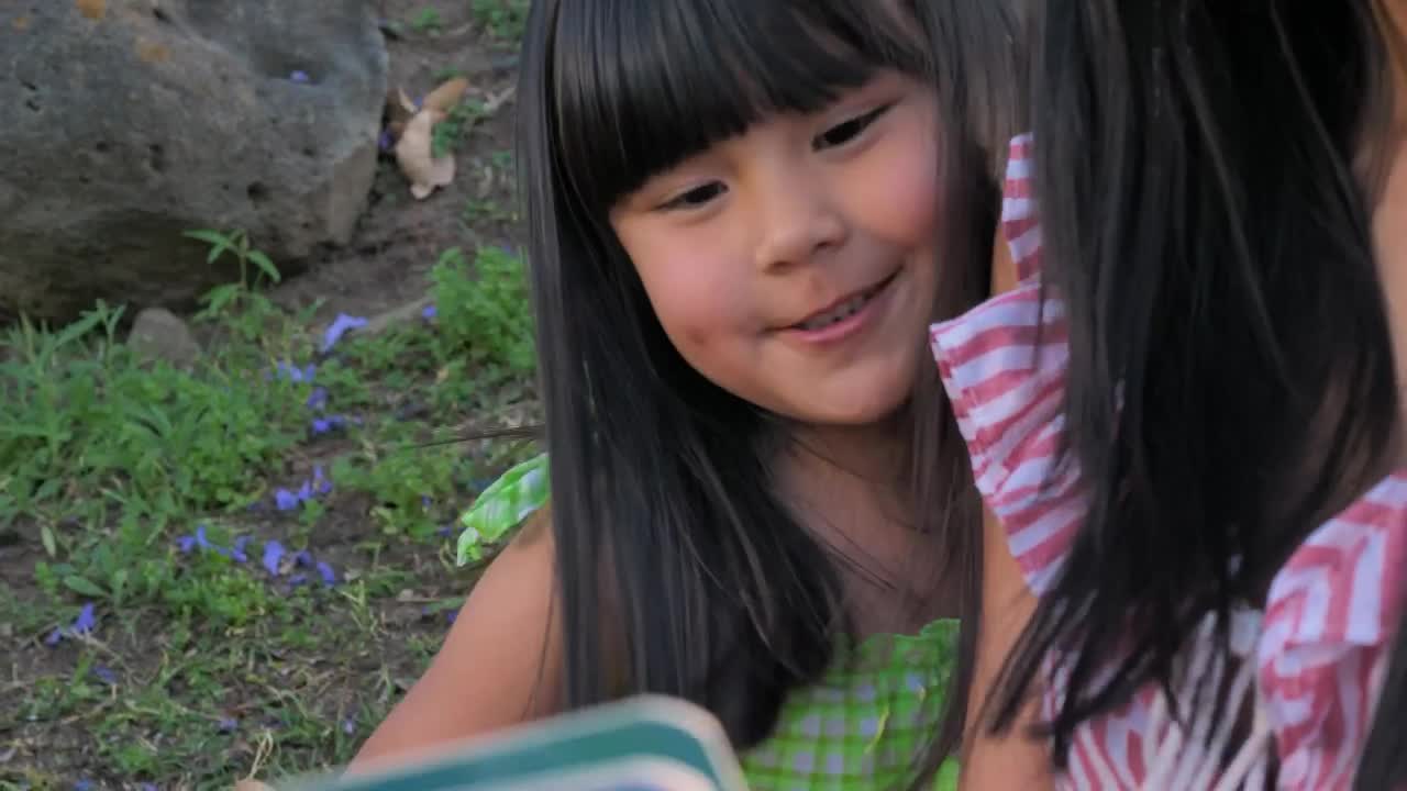 Stock Video Mother Reads A Story To Her Daughter Outdoor Animated Wallpaper