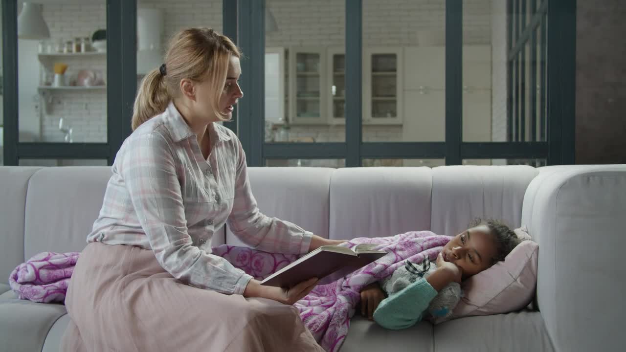 Stock Video Mother Reads A Book To Her Sick Daughte Animated Wallpaper