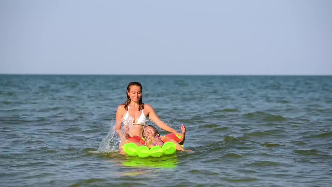 Stock Video Mother Playing With Her Daughters On A Floaty In Th Animated Wallpaper