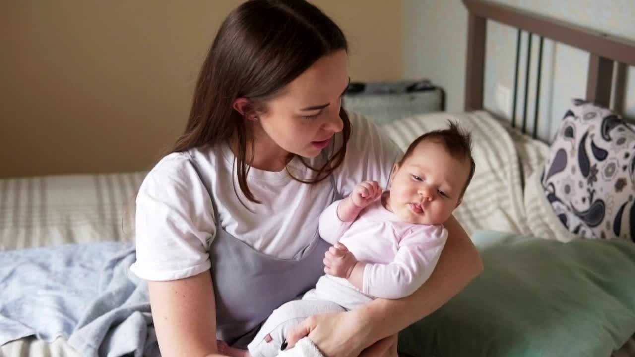 Stock Video Mother Holding Her Baby In Her Arm Animated Wallpaper