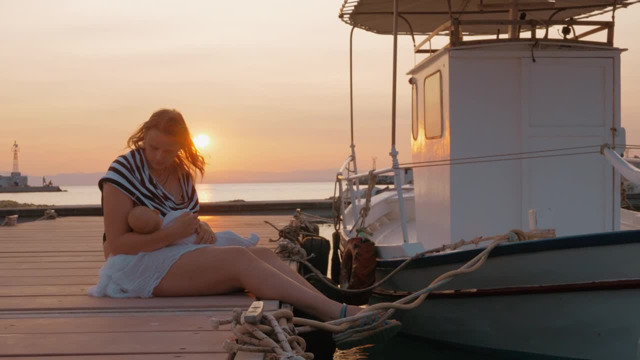 Stock Video Mother Holding Her Baby By A Boa Animated Wallpaper