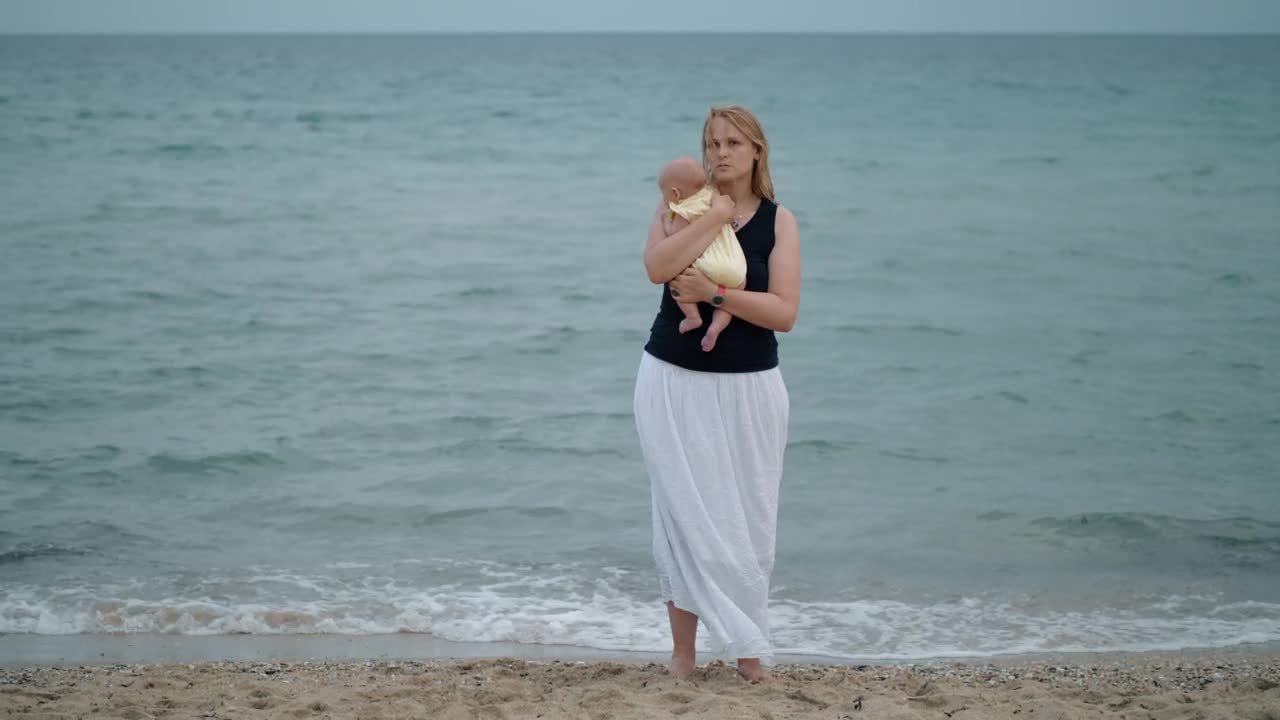 Stock Video Mother Holding Her Baby Alone At The Shor Animated Wallpaper