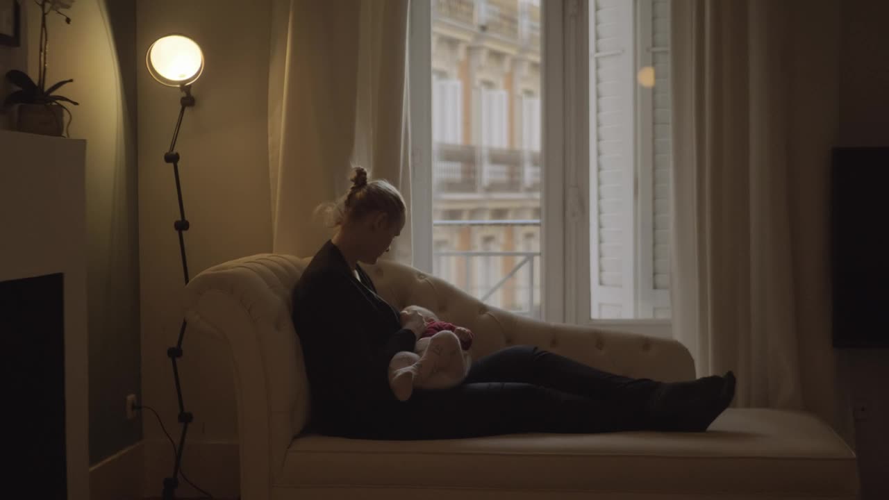 Stock Video Mother Feeding Her Young Baby At Hom Animated Wallpaper