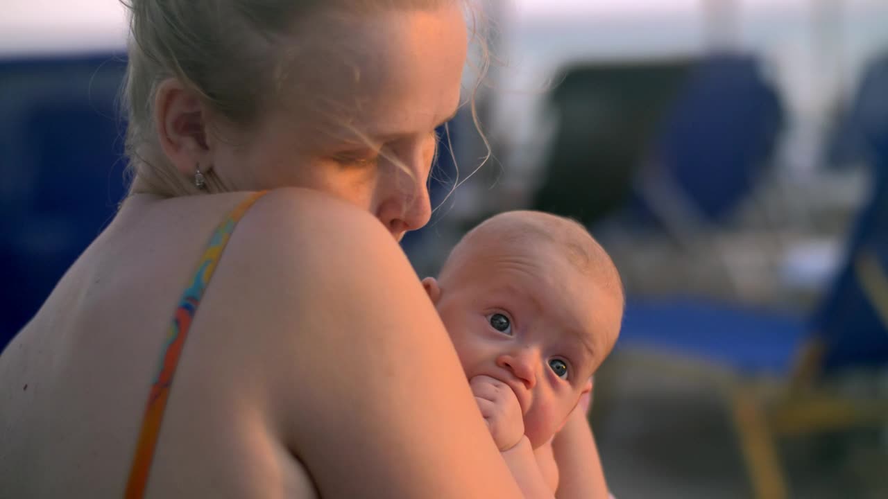 Stock Video Mother Carefully Holding Her Newborn Chil Animated Wallpaper