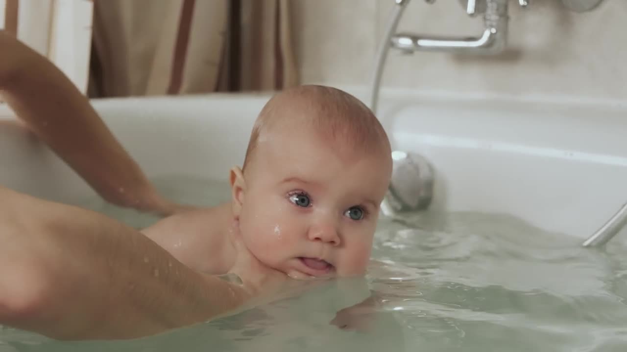 Stock Video Mother Bathing Her Baby In The Tu Animated Wallpaper