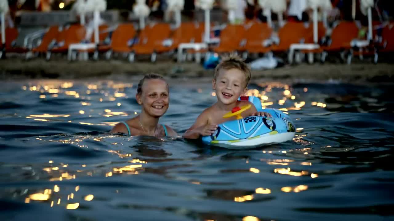 Stock Video Mother And Son With An Inflatable Rin Animated Wallpaper
