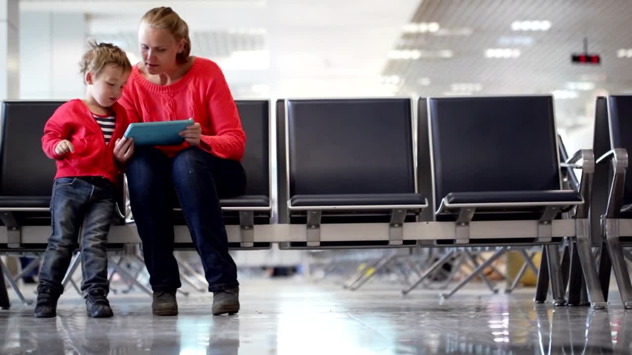 Stock Video Mother And Son Waiting For A Flight Announcemen Animated Wallpaper