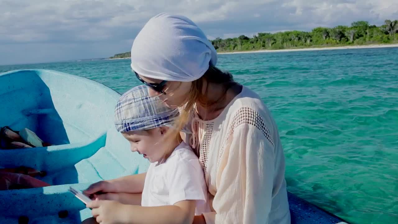 Stock Video Mother And Her Young Boy On A Small Boa Animated Wallpaper