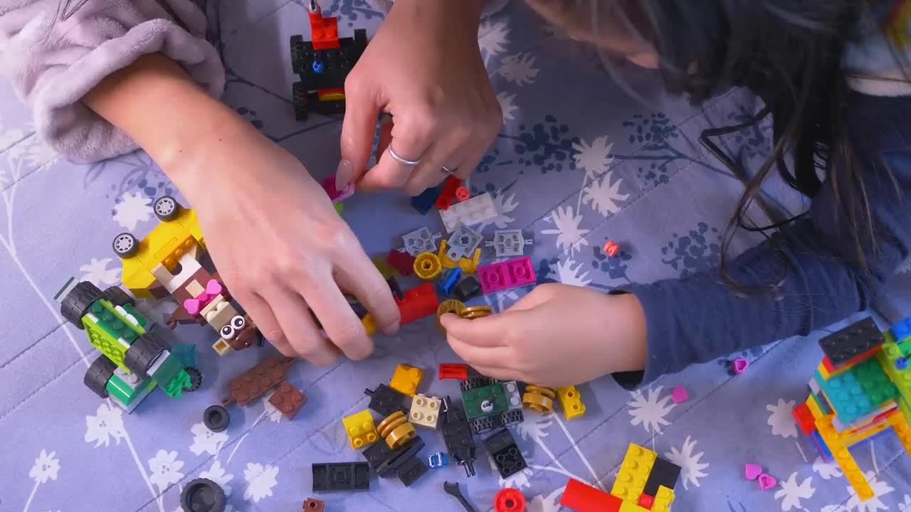 Stock Video Mother And Her Daughter Playing With Lego Piece Animated Wallpaper