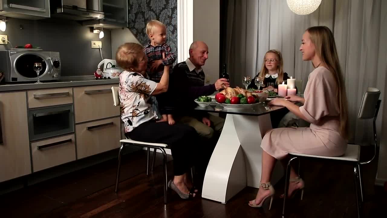 Stock Video Mother And Her Children At A Dinner With Grandparent Animated Wallpaper